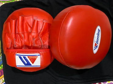 Red boxing gloves Punching Mitts on a black background