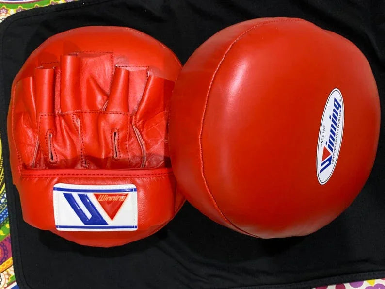 Red boxing gloves Punching Mitts on a black background