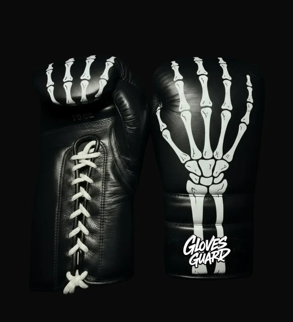 Black boxing gloves with skeleton design on a black background